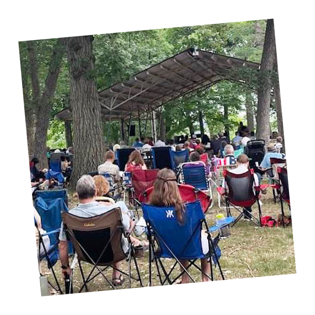 shot of people attending church service in the park.